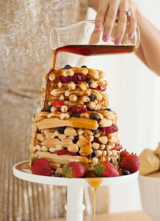 a waffle wedding cake with blueberries, strawberries and caramel on top is delicious and tasty