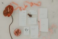 02 The wedding stationery was done with simple printing, blush and coral touches to contrast the snow