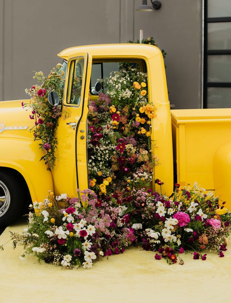 This gorgeous yellow truck was filled with bright blooms to make a statement decoration for this modern wedding shoot