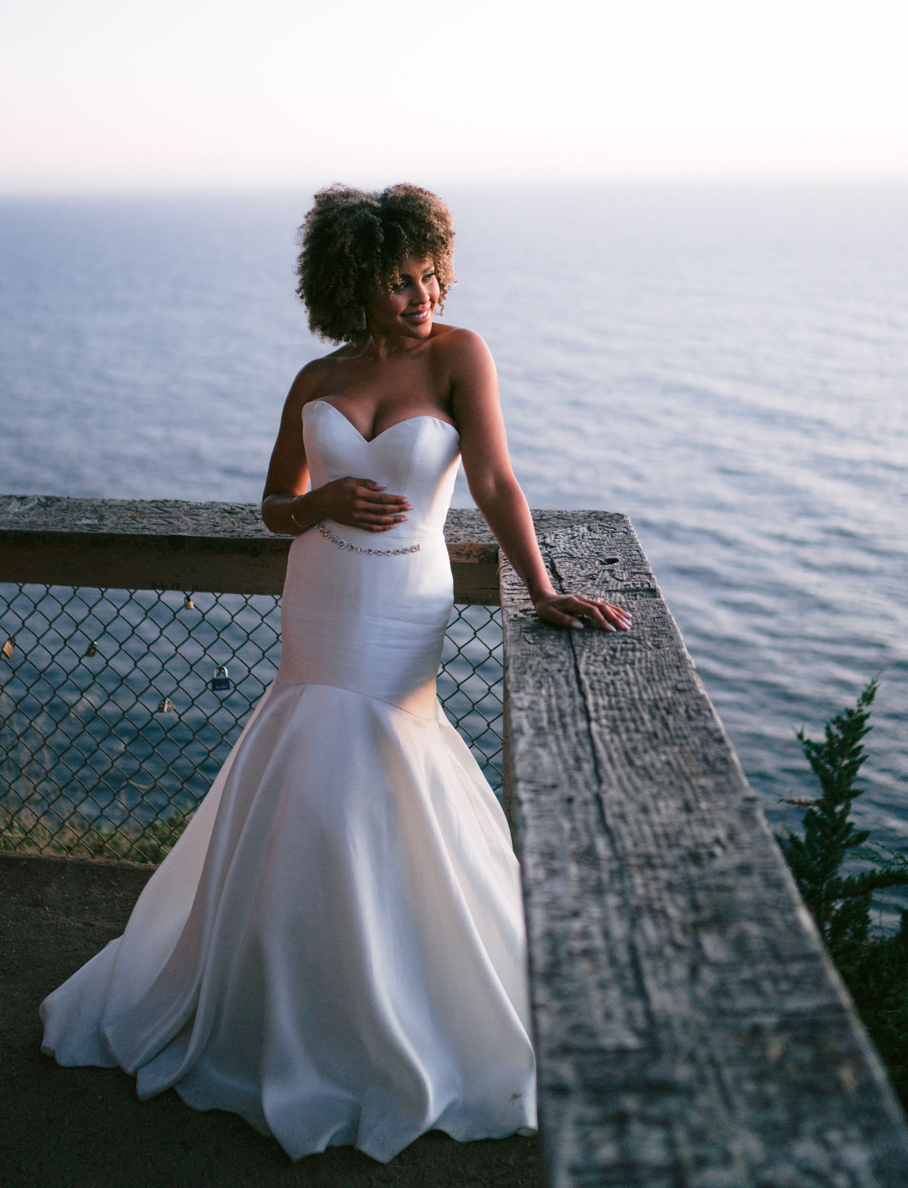 The bride was wearing a strapless mermaid wedding dress with an embellished sash and rocking her Afro hair