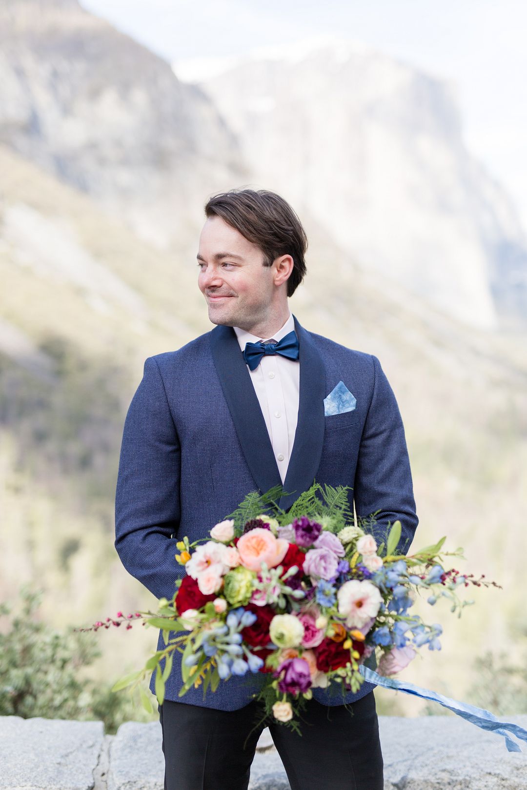 The groom was wearing a grey printed tux with black lapels, a navy bow tie and black pants