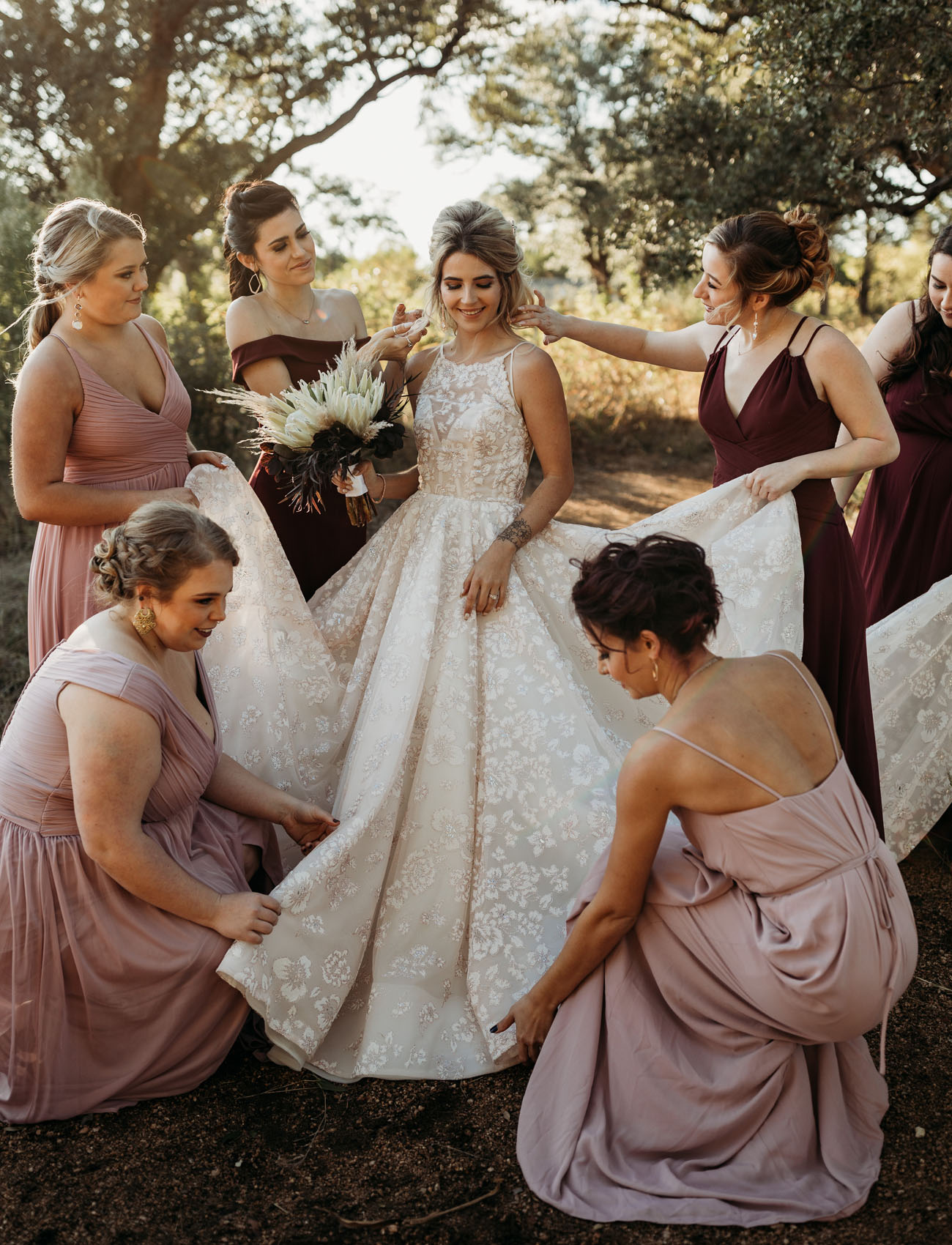 The wedding dress was a super romantic floral ballgown with an illusion neckline, the bridesmaids were wearing dusty pink and burgundy