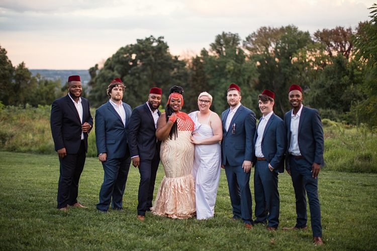 The groomsmen were dressed into navy suits and white shirts plus burgundy hats that are also traditional