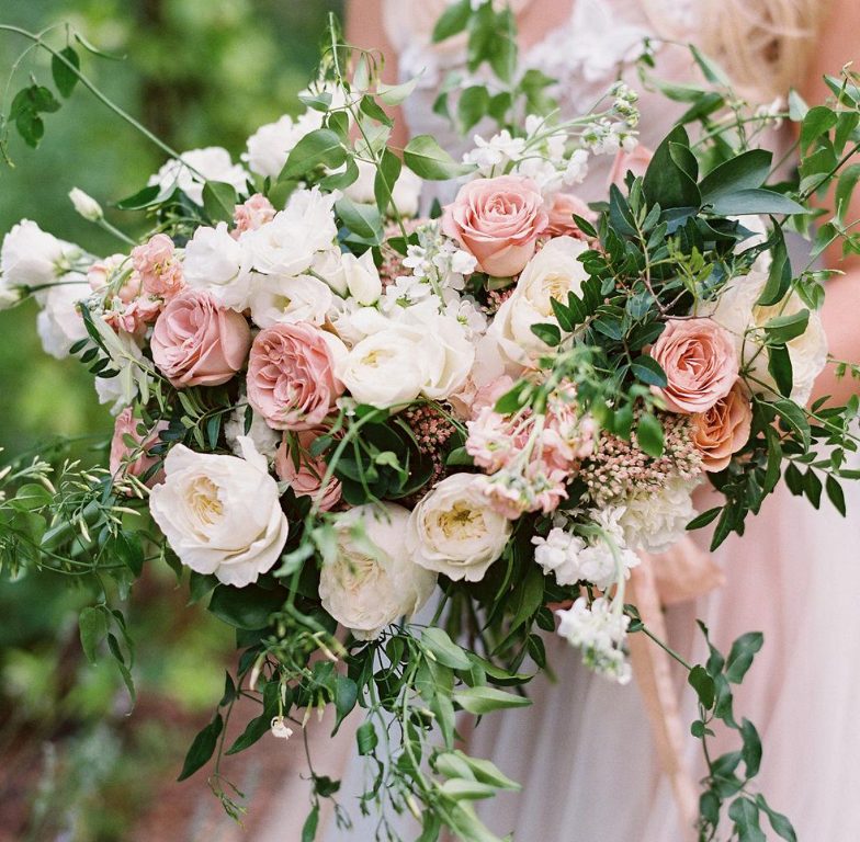 The wedding bouquet was done with white and pink blooms and lots of greenery and looked very lush