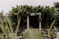 05 The wedding ceremony space was a tropical grove, with a white fabric arch and bold blooms