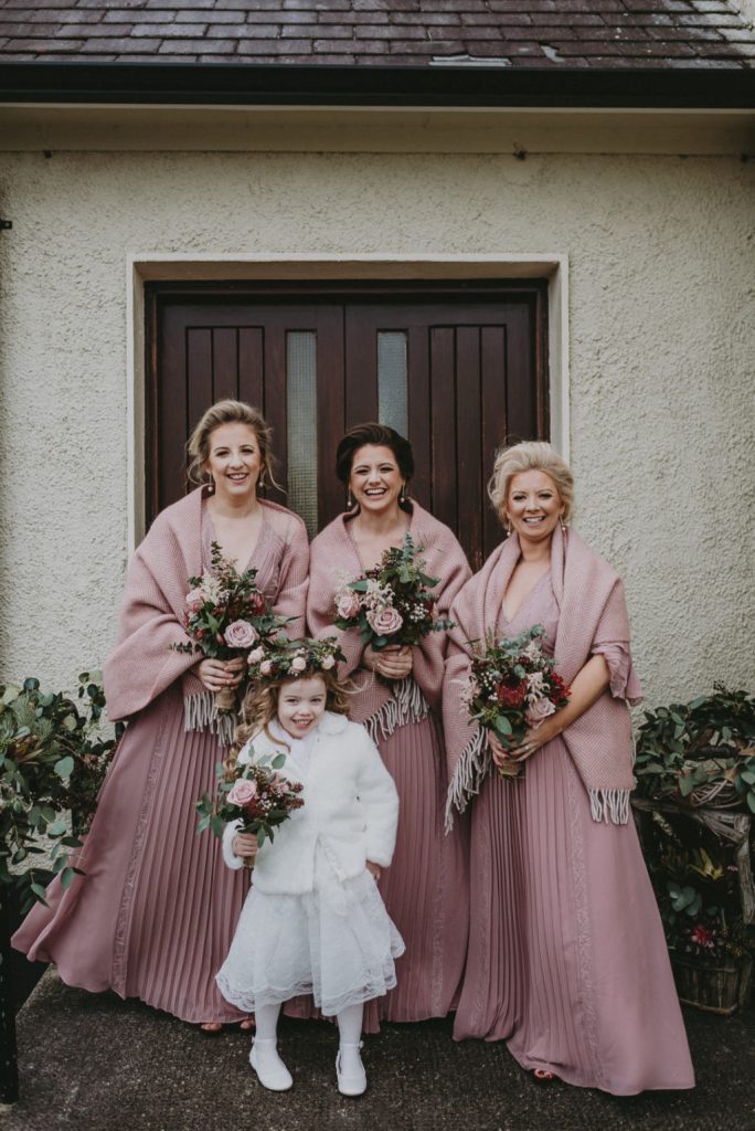 The bridesmaids were wearing dusty pink maxi dresses and cozy coverups, the flower girl was wearing all-white