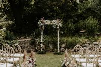 07 The wedding arch was decorated with lush blooms and greenery and the wedding aisle was decorated with them, too