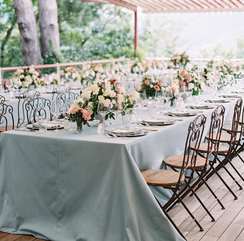 The wedding tablescapes were done with powder blue tablecloths, neutral and pink blooms and blue napkins