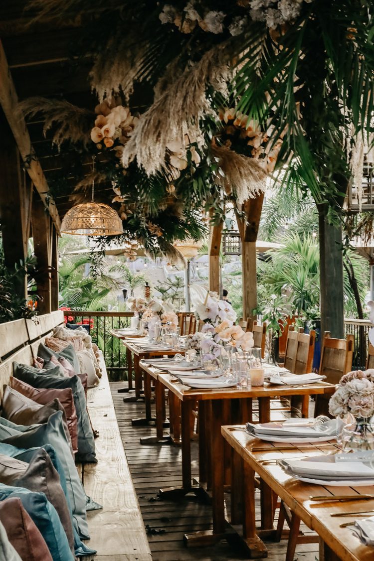 The wedding reception was truly tropical, with pampas grass, leaves and blush orchids over the tables