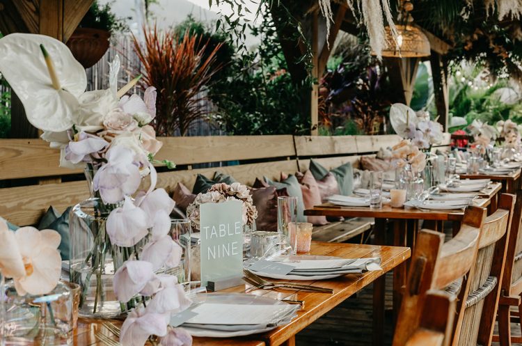 The tables were decorated with pastel and white blooms, candles and pastel napkins