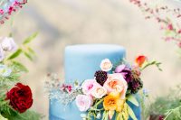 a cute light blue wedding cake with flowers