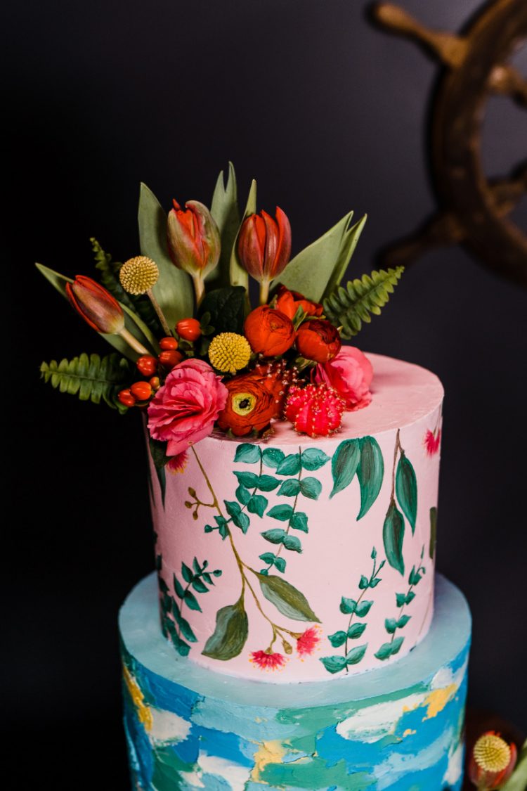The wedding cake featured a bright abstract tier and a botanical painted one, bright blooms and leaves and cacti
