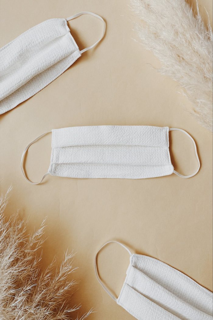 a simple washable white fabric face mask is a nice accessory that will match many outfits