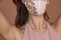 19 a white face mask embellished with gold lace and embroidery is a romantic and beautiful bridal accessory