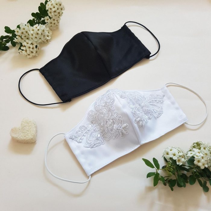 a black plain mask for a groom and a white lace and embellished mask for a bride are stylish and chic