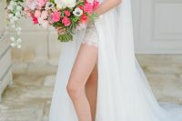 03 The bride was wearing a gorgeous embellished wedding dress with a plunging neckline, a cape and an overskirt