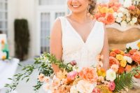 03 The bride was wearing a lace sleeveless A-line wedding dress with a deep V-neckline and carrying a bright textural bouquet
