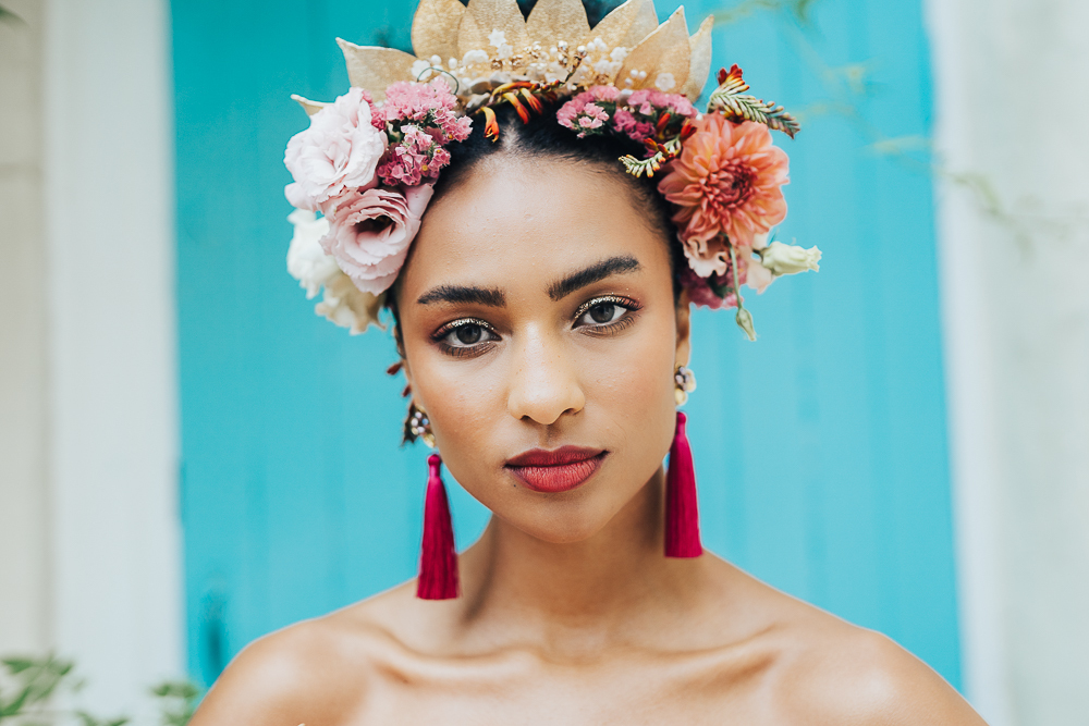 The floral and dried leaf crown was paired with hot pink tassel earrings and a pink lip