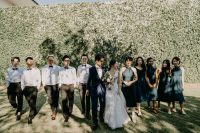 03 The groomsmen were wearing black pants and bow ties and white shirts, and bridesmaids were wearing navy halter neckline midi dresses