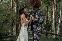 04 The groom was wearing a black floral suit, a black shirt and boots and his Afro hair perfectly finished off his look