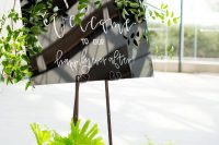 04 The wedding signage was modern, decorated with various kinds of greenery