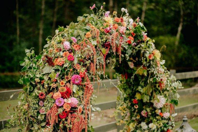 The fantastic wedding arch was done with bright blooms and greenery that were grown by the groom's family
