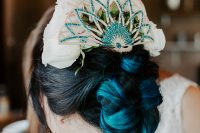 05 The wedding hair was a twisted updo with a whimsy peacock headpiece and white roses