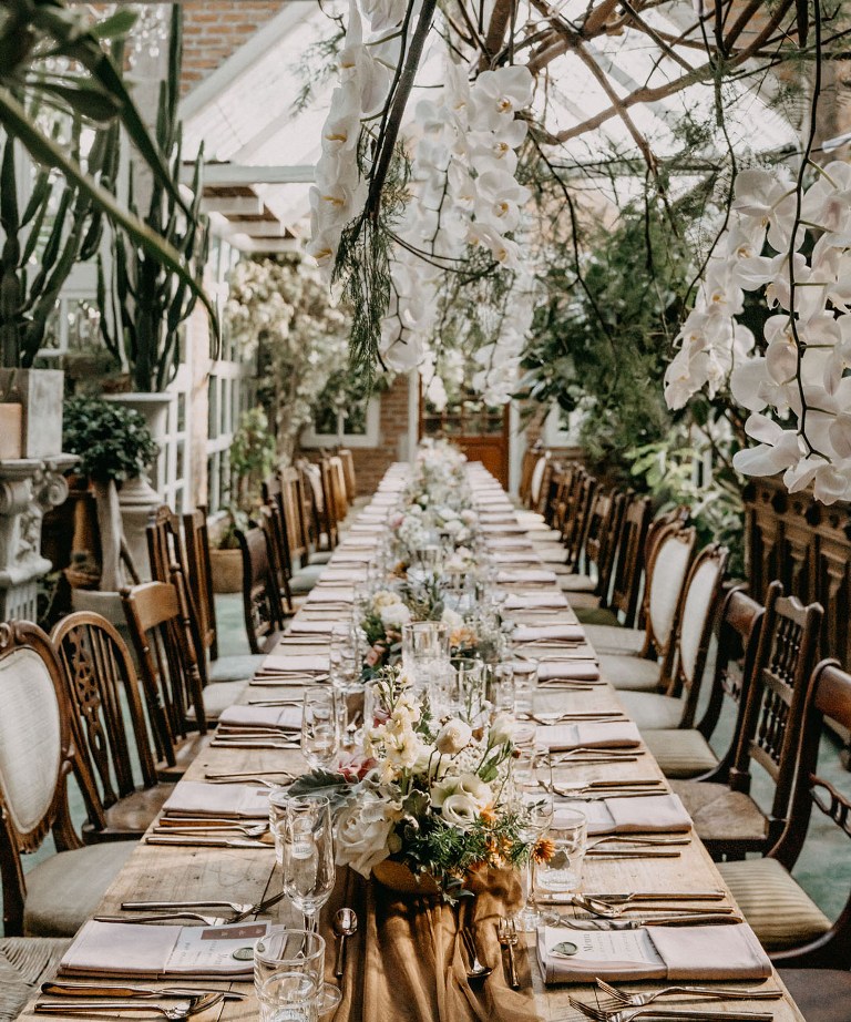 The tables were lined up with white, blush and copper blooms and greenery and lots of greenery around