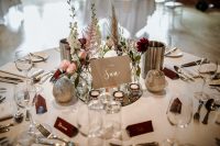 07 The tables were elegantly decorated with burgundy and blush blooms, herbs, candles and burgundy cards