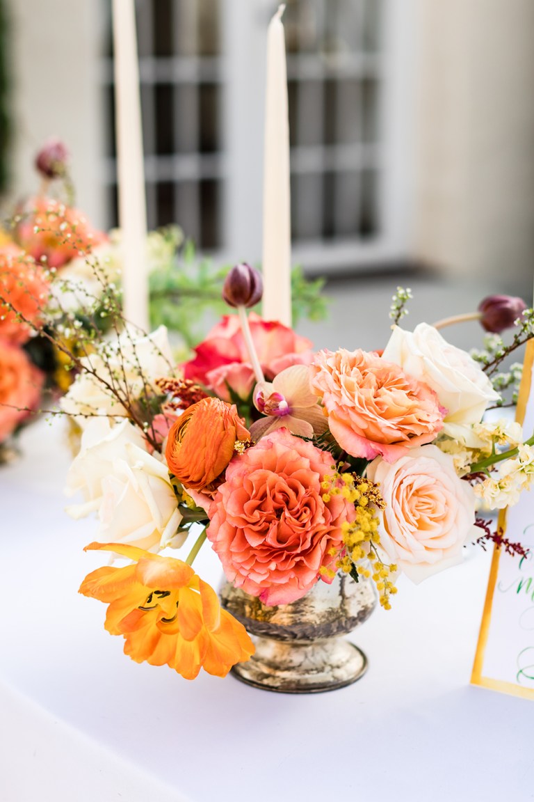 The wedding florals were done bright, with pink, peachy and rust shades
