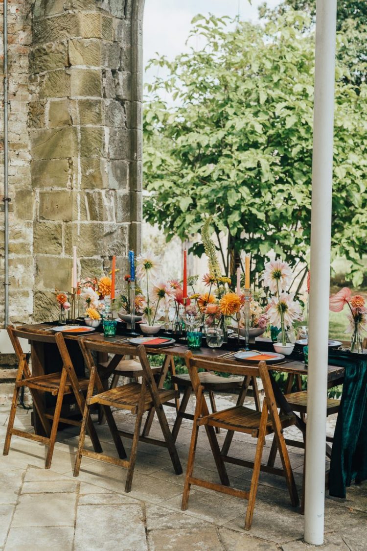 The wedding tablescape was super bold, with bright blooms and candles and stationery