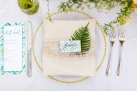 08 The place setting was done with a gold edge plate, a linen lace napkin and bright tropical stationery