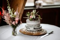 08 The wedding cake was a naked one, with greenery, burgundy and blush blooms on top