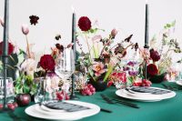 08 The wedding tablescape was done with an emerald tablecloth, black candles, jewel tone blooms and fresh fruit on the table