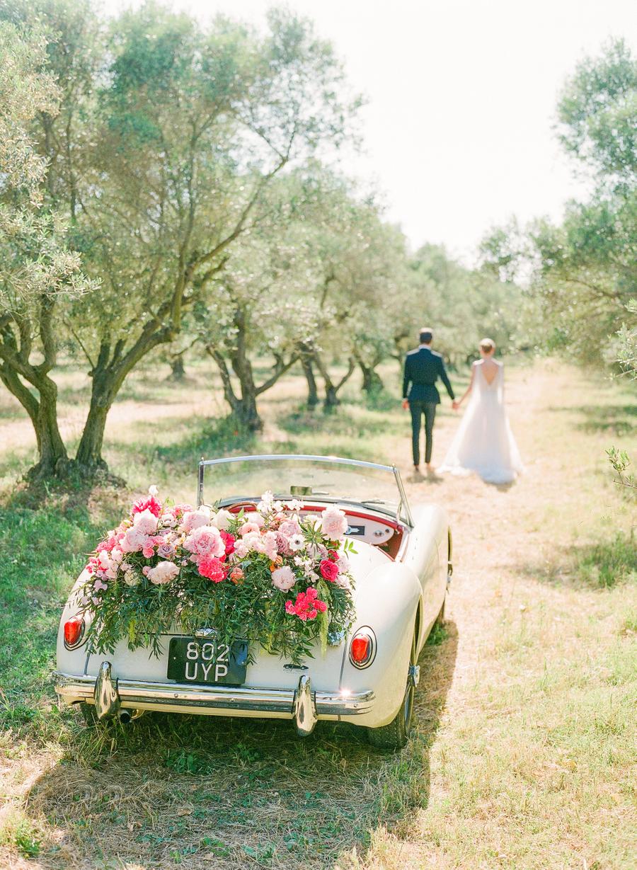 The getaway car was done with lush florals and greenery and looked amazing