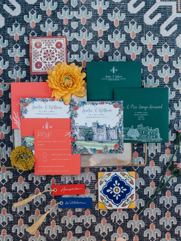 This invitation suite includes orange, hunter green and floral cards and azulejo tiles