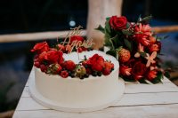 11 The wedding cake was a white one, with red roses and fresh berries plus a calligraphy topper