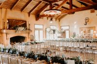 11 The wedding reception space was done with greenery, neutral blooms, blue glasses and candles and looked gorgeous