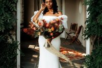 02 The bride was wearing a breathtaking classic sheath wedding dress with a train with catchy sleeves and a bold floral crown