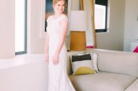 02 The bride was wearing a stylish cap sleeve sheath wedding dress of lace, with a high neckline and a train plus an updo
