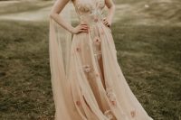 02 a beautiful nude wedding dress with floral appliques, a gauzy skirt, an open back and a capelet