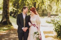 03 The bride was wearing a blush wedding dress with a lace embroidered bodice and burgundy floral embroidery, a deep neckline and a half updo