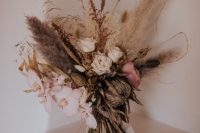 03 The wedding bouquet was with blush and pink blooms and lots of dried elements and ribbons