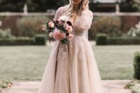 03 a blush and white A-line wedding dress with a deep neckline, long sleeves is a very romantic piece for a fairy-tale bride