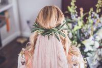 03 a boho wedding dress decorated with blooms and a blush veil attached to a greenery halo look fantastic