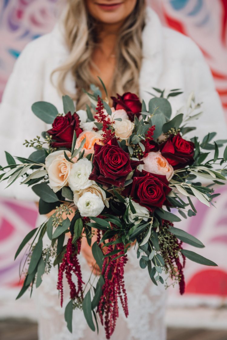 Her bright bouquet was done with peachy, white and burgundy blooms and greenery