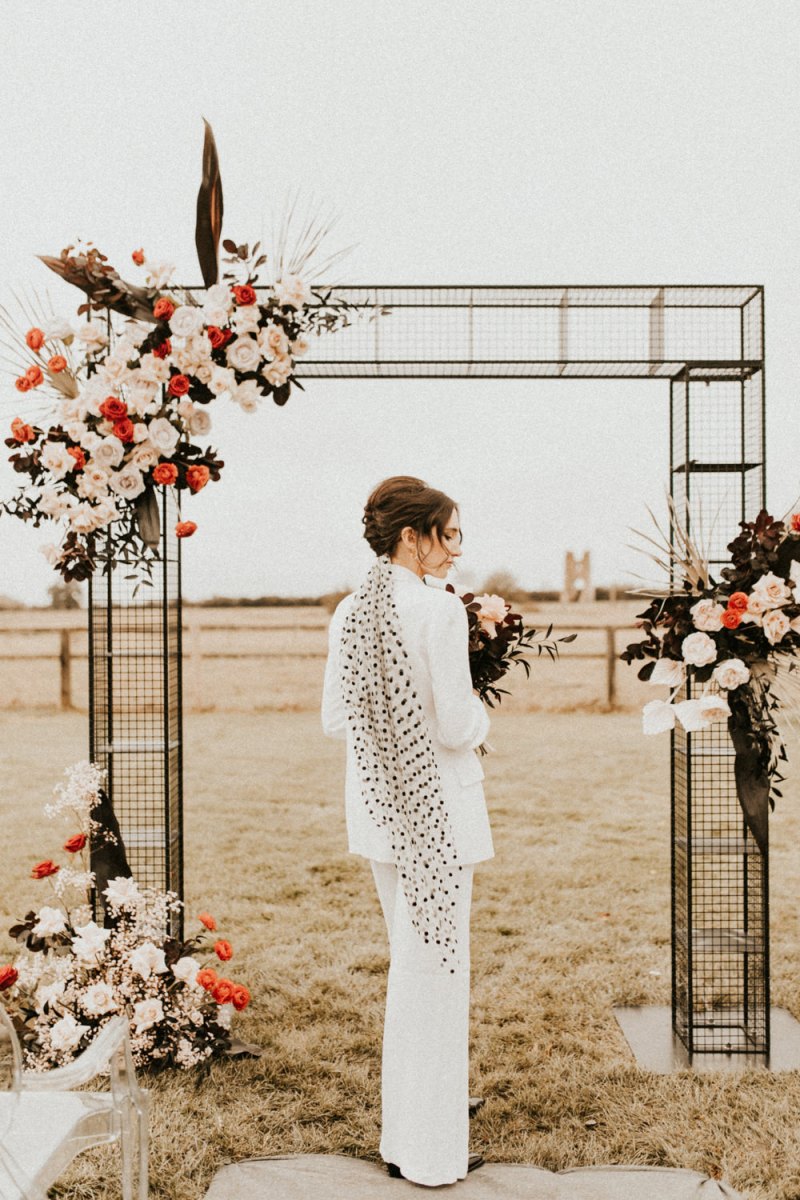 The second bridal look was done with a white pantsuit and a polka dot veil