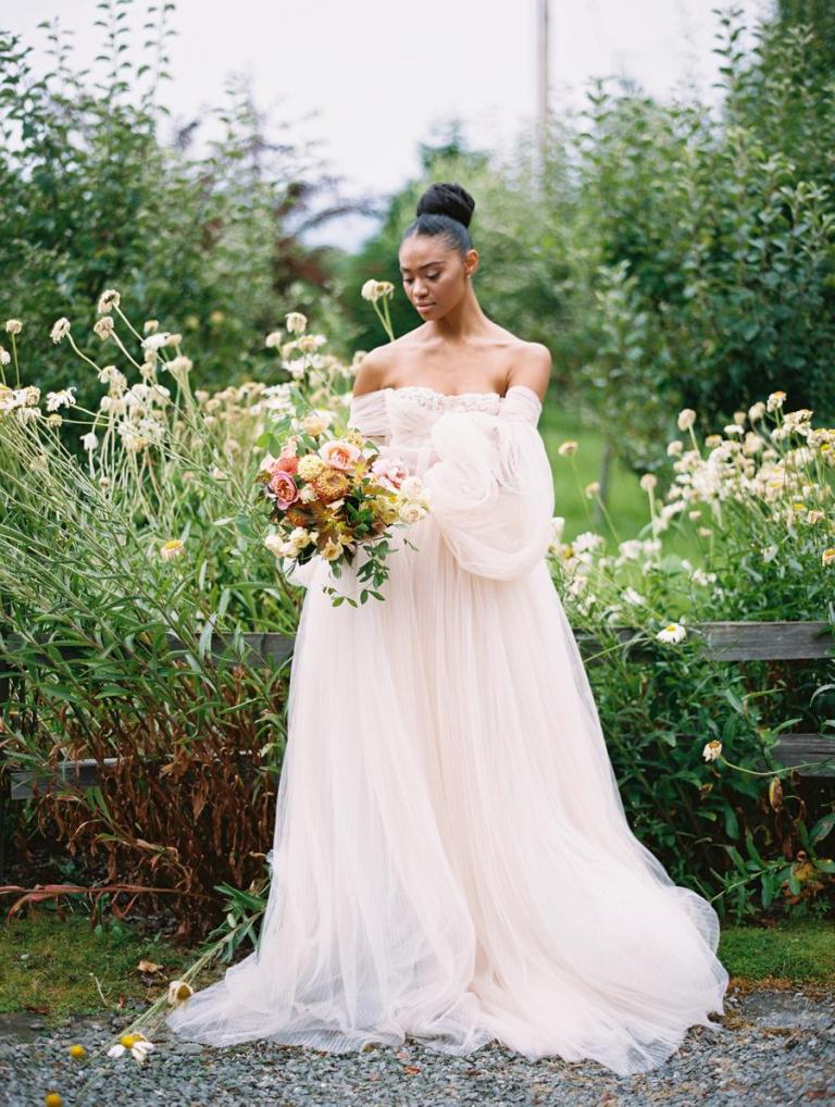The second wedding dress was a refined flowy off the shoulder blush wedding gown