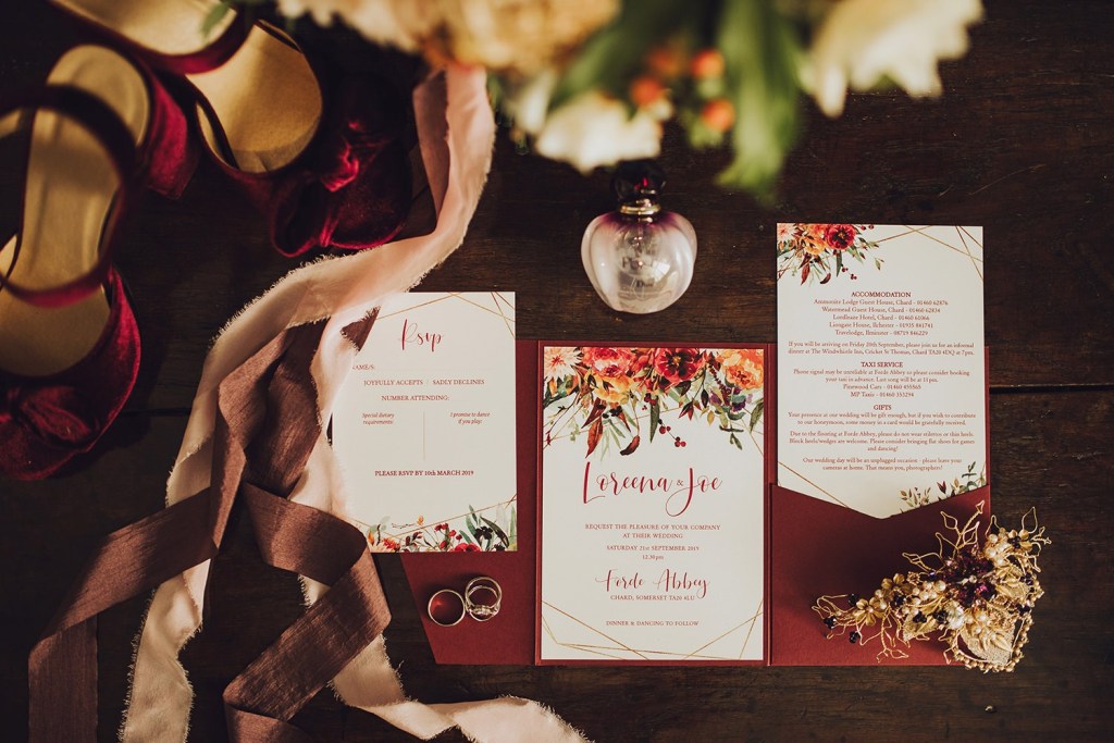 The wedding stationery was elegant, with burgundy blooms and the bridal shoes were of burgundy velvet