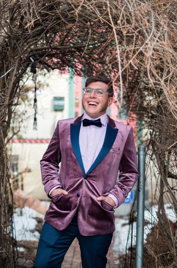 The groom was wearing a purple velvet tux with navy lapels and navy pants, a navy velvet bow tie